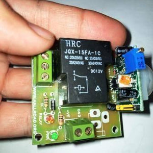 12V PIR Motion Sensor Switch Module - a black relay, green screw terminals, a blue potentiometer, and a green status LED.