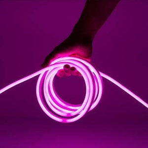 12V Purple Neon Flexible Strip Light 1m Waterproof SMD 5050 Rope String Silicone Lamp Outdoor Lighting - shown as a glowing purple coil of silicone rope being held by a hand against a matching purple background.