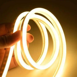 12V Warm White Neon Flexible Strip Light 1m Waterproof SMD 5050 Rope String Silicone Lamp Outdoor Lighting - shown as a coiled, glowing warm white silicone LED rope being held by a hand.