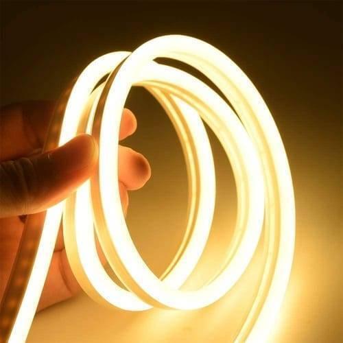 12V Warm White Neon Flexible Strip Light 1m Waterproof SMD 5050 Rope String Silicone Lamp Outdoor Lighting - shown as a coiled, glowing warm white silicone LED rope being held by a hand.