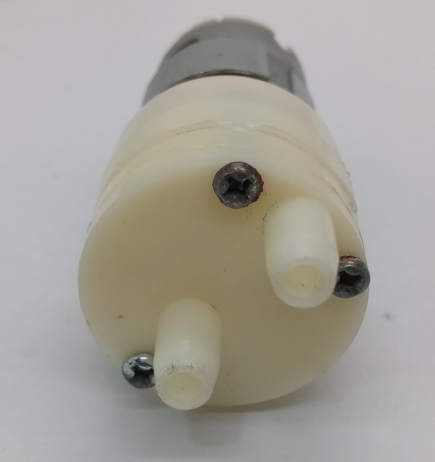 12V Water Cooler Pump stock lot - a close-up view of the white plastic pump head featuring two protruding nozzles and three Phillips head mounting screws.