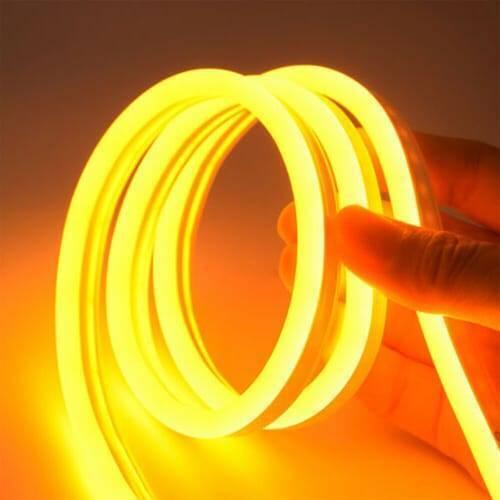 12V Yellow Neon Flexible Strip Light 1m Waterproof SMD 5050 Rope String Silicone Lamp Outdoor Lighting - shown as a coiled, glowing yellow silicone rope being held by a hand.