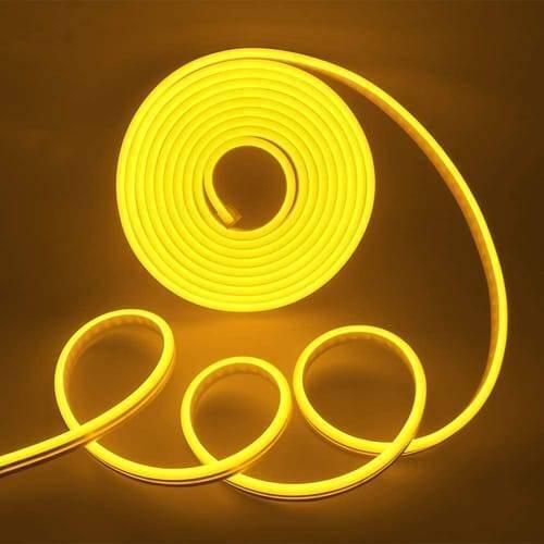 12V Yellow Neon Flexible Strip Light 1m Waterproof SMD 5050 Rope String Silicone Lamp Outdoor Lighting - coiled into a spiral and loose loops, glowing with a bright yellow light against a dark background.