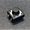 12x12x7.5mm Tactile Push Button Switch - a black square tactile switch with a round center button and four metal pins, shown in a close-up view.