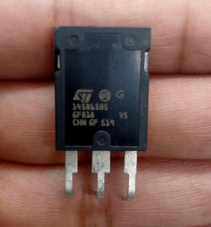145A 650V MOSFET 145N65HS GF818 Chn - High-efficiency Power Transistor - a black rectangular electronic component with three metal pins, held between fingers, showing the printed text on its front surface.