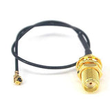 150mm Length For 2mm Size 1st Generation Ipex To SMA Female Antenna Connector - a black coaxial cable with a small Ipex connector and a gold SMA port.