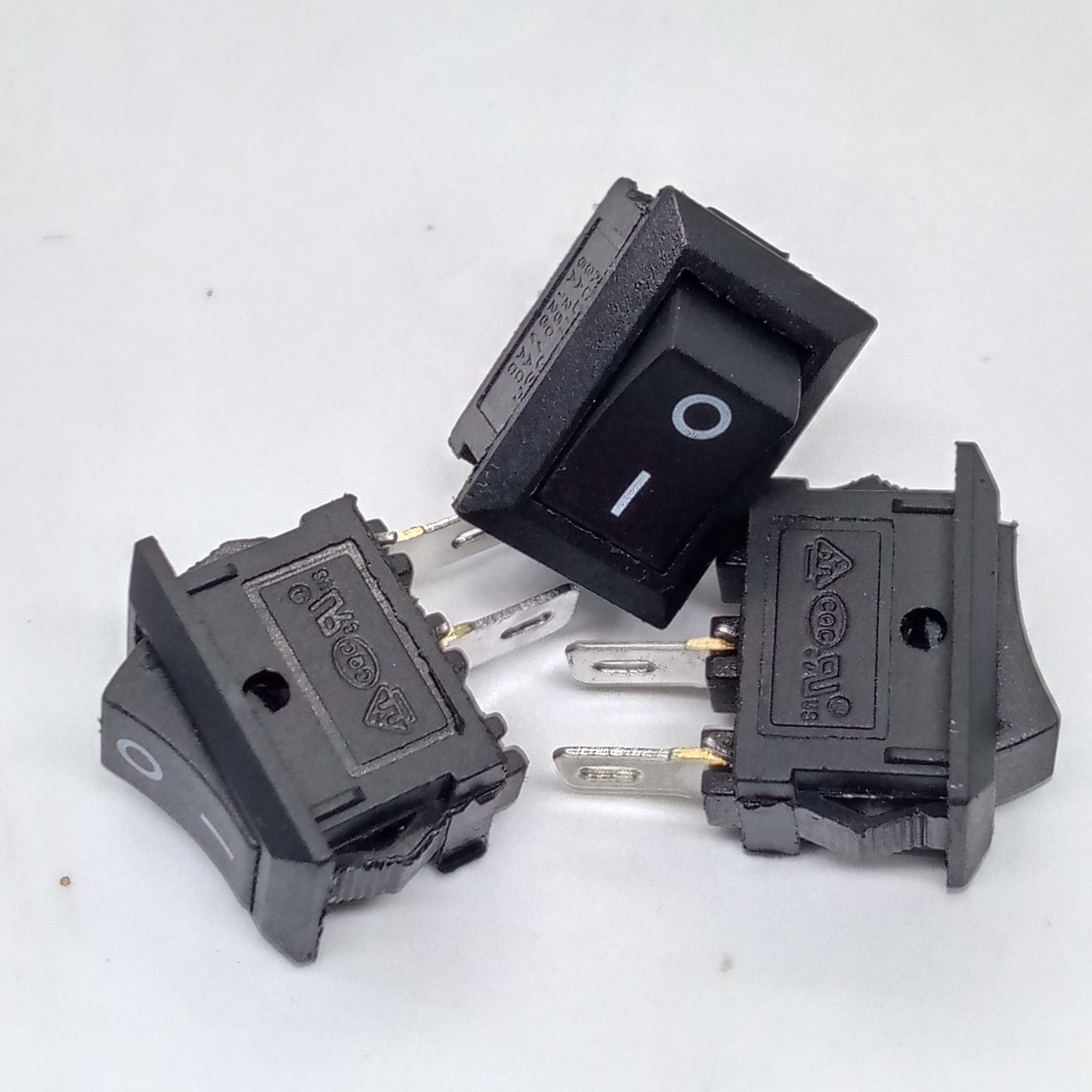15MMX10MMX8MM KCD11 Rocker Switch 3A - three small black rectangular rocker switches with two metal terminals each, featuring O-I markings on the switch surface.