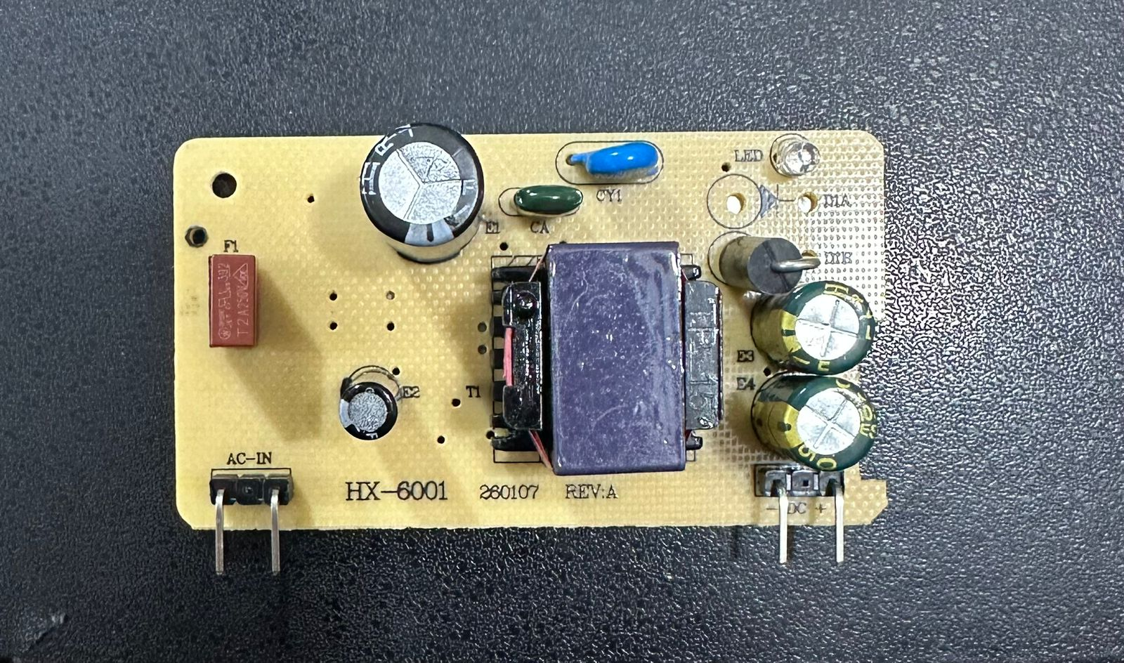 15V 2A Power Supply for Solar Inverters - a yellow circuit board with a transformer, capacitors, AC-IN pins, and DC output pins labeled HX-6001.