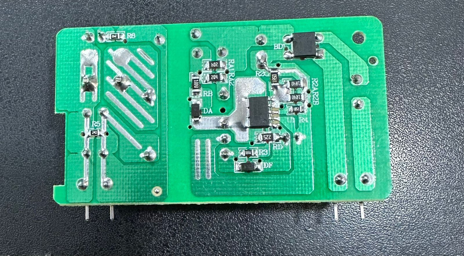 15V 2A Power Supply for Solar Inverters - a close-up of the green printed circuit board with various electronic components and soldering points.