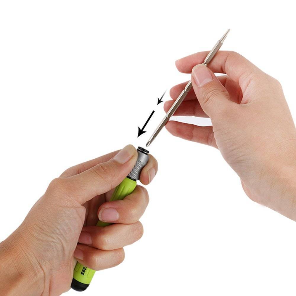16 In 1 Multi Functional Screwdriver Precision Set - a hand inserting a double-ended metal screwdriver bit into the green and silver handle.