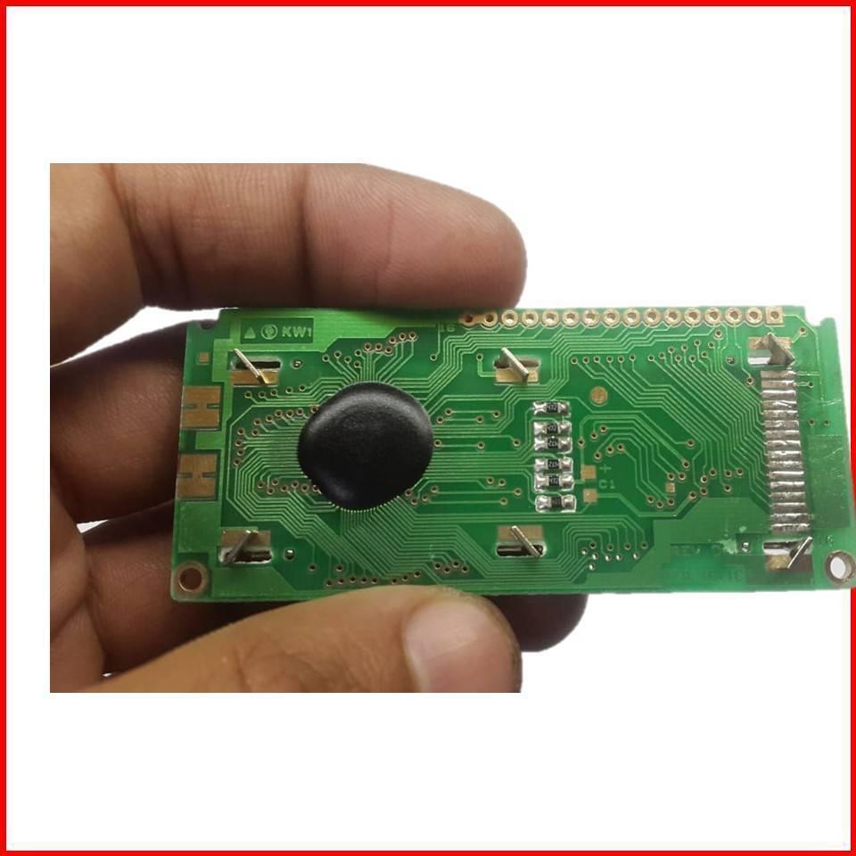 1601 LCD 16x1 LCD 16×1 Character LCD Without Back Light Display - rear view showing a green rectangular circuit board with a black epoxy-covered chip, surface-mount components, and pins.