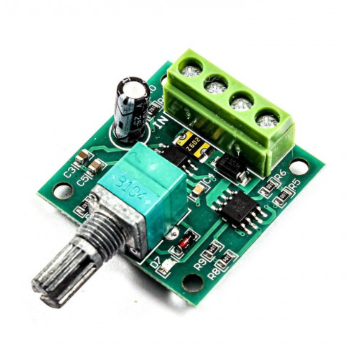 1803BK 30W DC Motor PWM Speed Controller – Precise Motor Control | Digilog.pk - a green circuit board, a rotary knob, a three-terminal screw connector, and a cylindrical capacitor.