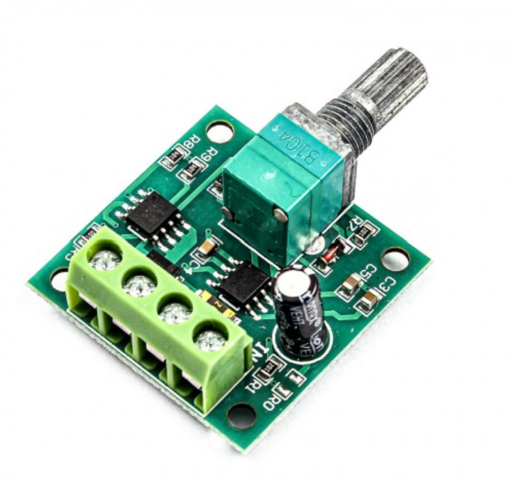 1803BK 30W DC Motor PWM Speed Controller – Precise Motor Control | Digilog.pk - a green circuit board with a silver rotary knob, a four-terminal screw connector, and two black IC chips.