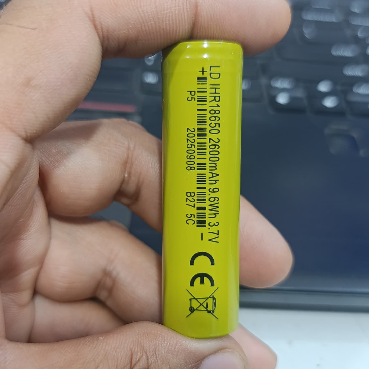 18650 1600mAh 3.7V Li-ion Rechargeable Cell For DIY Projects - a close-up view of a lime green cylindrical battery with printed technical specifications and a barcode.