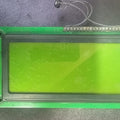 19264 LCD 92*64 Electronic Display Components Graphics Modules LCD Display Monitors LCD Modules - a rectangular green screen mounted on a green circuit board with a small black component connected by two thin wires.