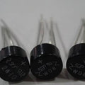 1A Bridge Rectifier 2W10 - three round, black electronic components with four metal pins each and printed model markings.