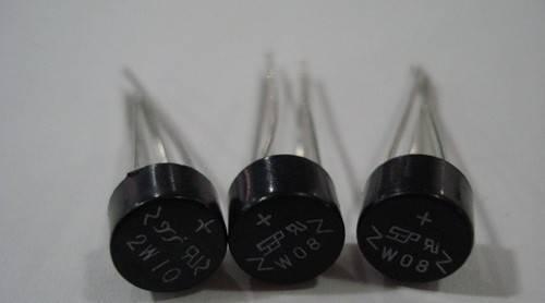 1A Bridge Rectifier 2W10 - three round, black electronic components with four metal pins each and printed model markings.