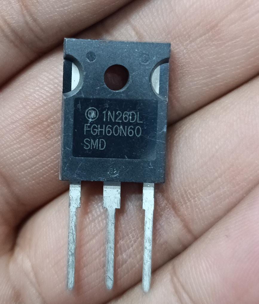 1N26DL FGH60N60 SMD IGBT - a black three-pin electronic component held between fingers, showing the model number printed on its face.