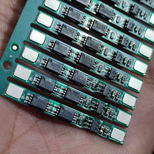 1s 4A BMS Module For Li Ion Batterey 259-fdc-3540 - a strip of multiple green printed circuit boards with 8205A chips, held in a hand.
