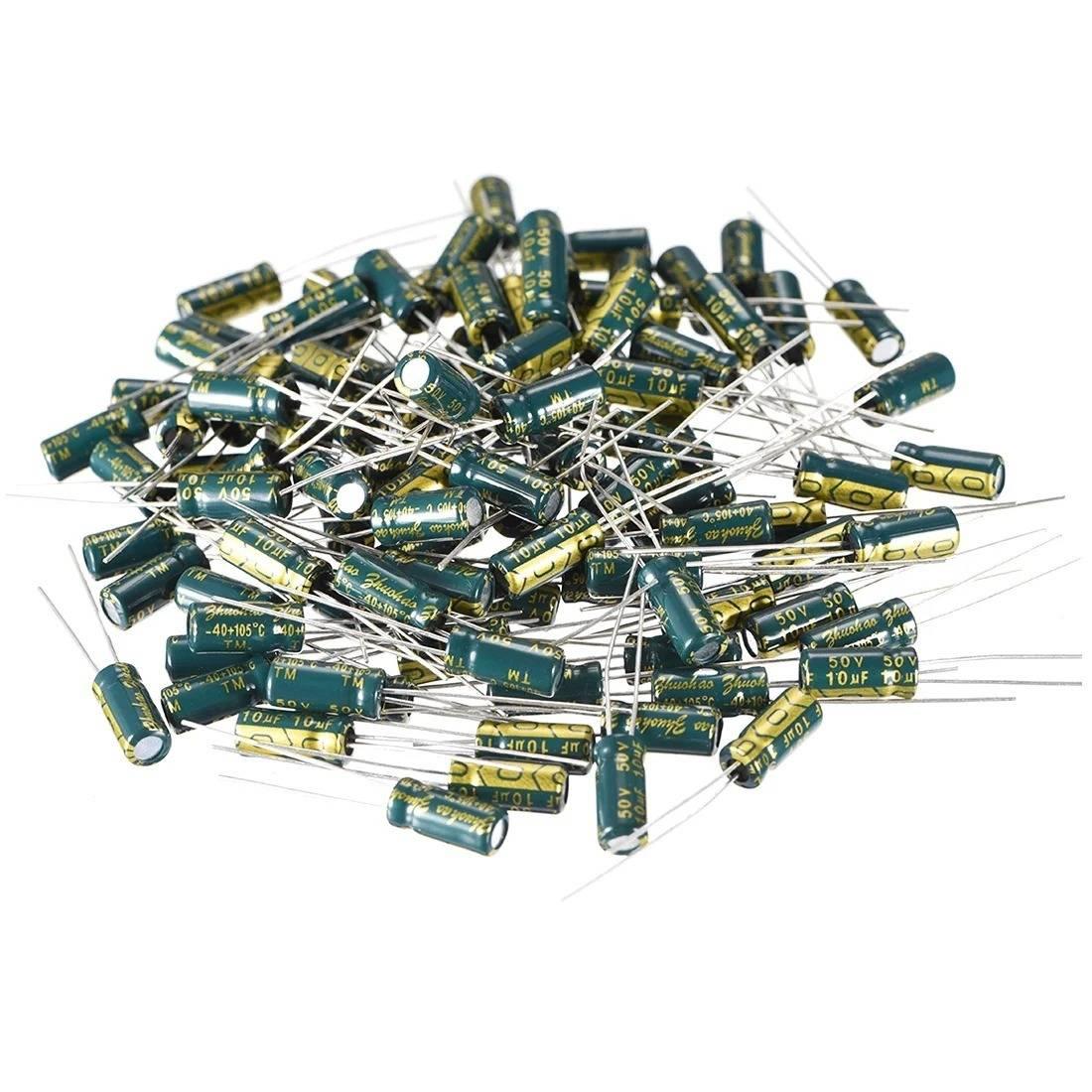 1uF 50V Electrolytic Capacitor Radial - a large pile of small, cylindrical green electrolytic capacitors with metal leads.