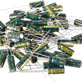 1uF 50V Electrolytic Radial Capacitor - a large pile of green cylindrical capacitors with two metal wire leads extending from each base.