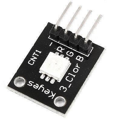 1watt RGB LED Module Ky 009 - a black rectangular circuit board with a central LED and four labeled pin connectors for -, R, G, and B.