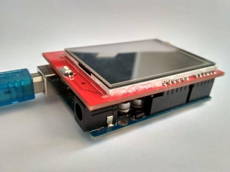 2.4 Inch TFT LCD Shield For Arduino ESP32 Solar Inverter - shown as a red display module plugged into a blue microcontroller board with a USB cable attached.
