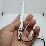 2.4GHz-5.8GHz 5db Wi-Fi Antenna With Ipex Connector - held in a hand, showing a white antenna with an attached thin black cable and a gold IPEX connector.