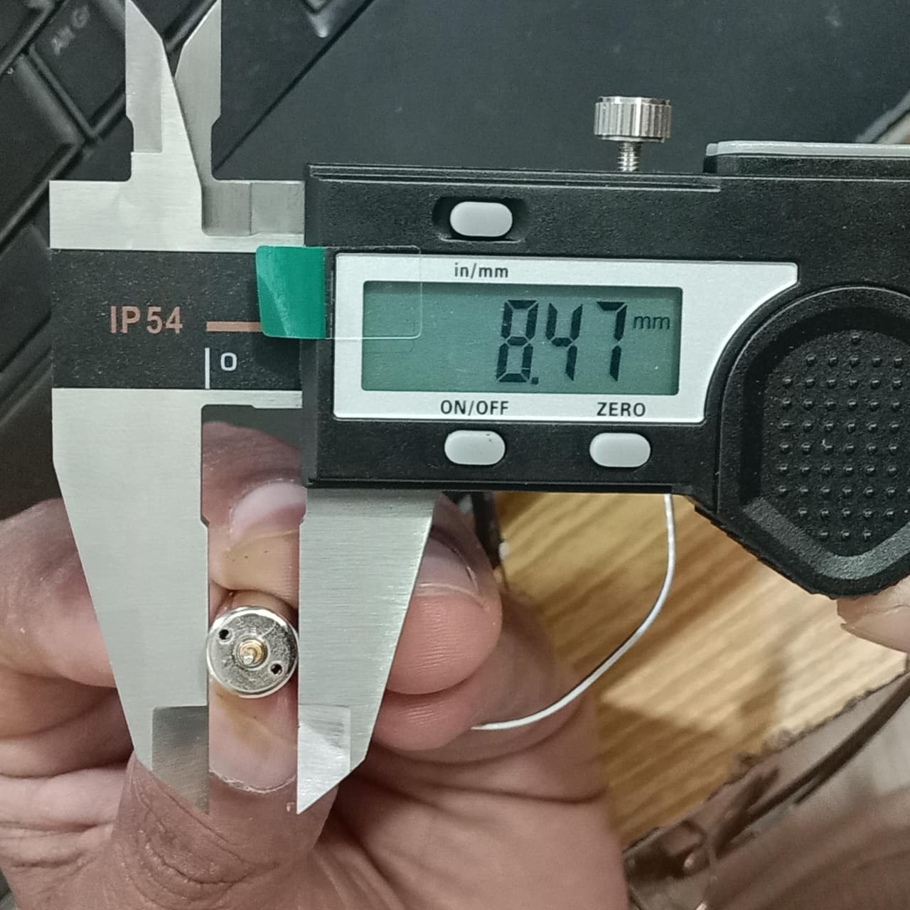 2 Pieces 1 Pair Helicopter Coreless Micro DC Motor with Propeller - close-up showing a silver micro motor being measured by digital calipers at 8.47mm.