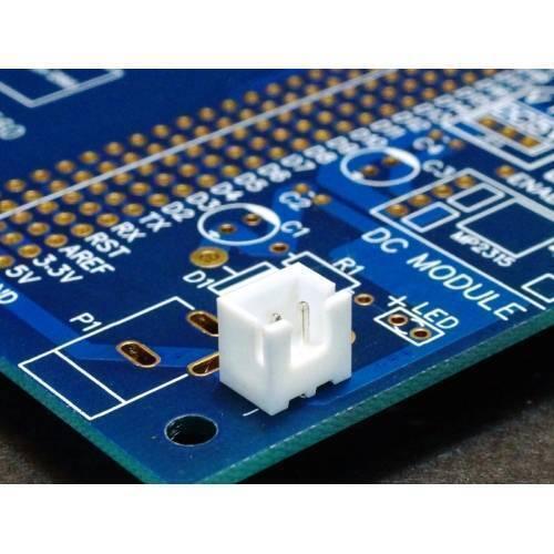 2 Pin 2.54mm JST Xh Style PCB Mount Male Connector - shown as a white two-pin connector soldered onto a blue printed circuit board.