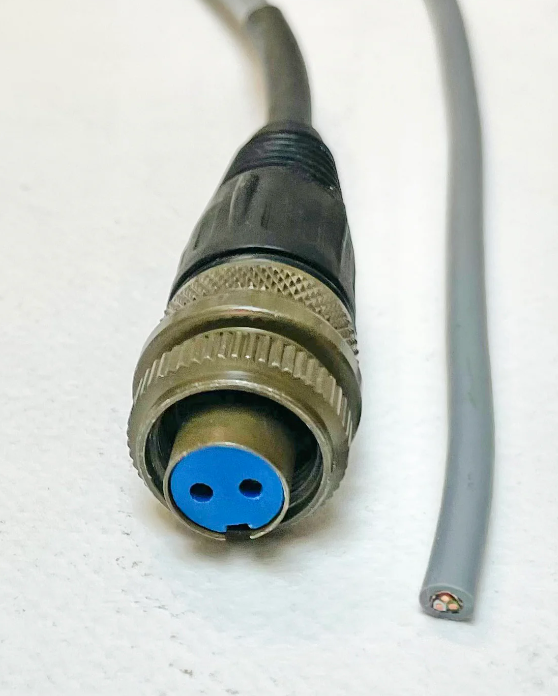 2 Pin Military Connector - Durable & Reliable Connections | Digilog.pk - a close-up of a circular metal connector with a blue two-pin insert and a gray cable with exposed wires.