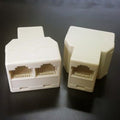 2 port junction box - two white plastic telephone splitters, one with two RJ11 ports and one with a single RJ11 port.