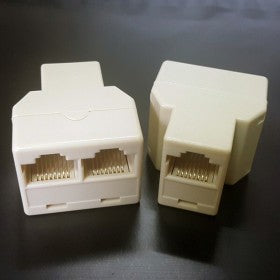 2 port junction box - two white plastic telephone splitters, one with two RJ11 ports and one with a single RJ11 port.