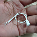 2 Wires 2.54mm Pitch Female JST Xh Connector Cable Wire - shown as a close-up of a white two-pin connector with two attached white wires held in a hand.