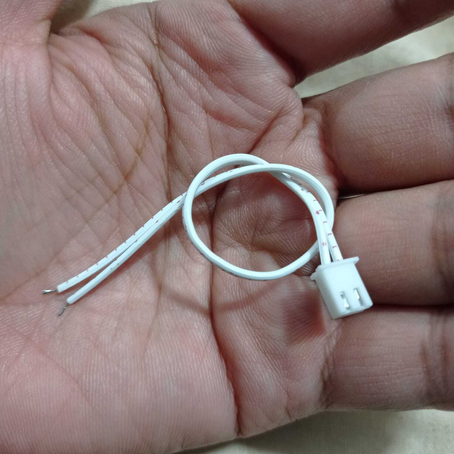 2 Wires 2.54mm Pitch Female JST Xh Connector Cable Wire - shown as a close-up of a white two-pin connector with two attached white wires held in a hand.