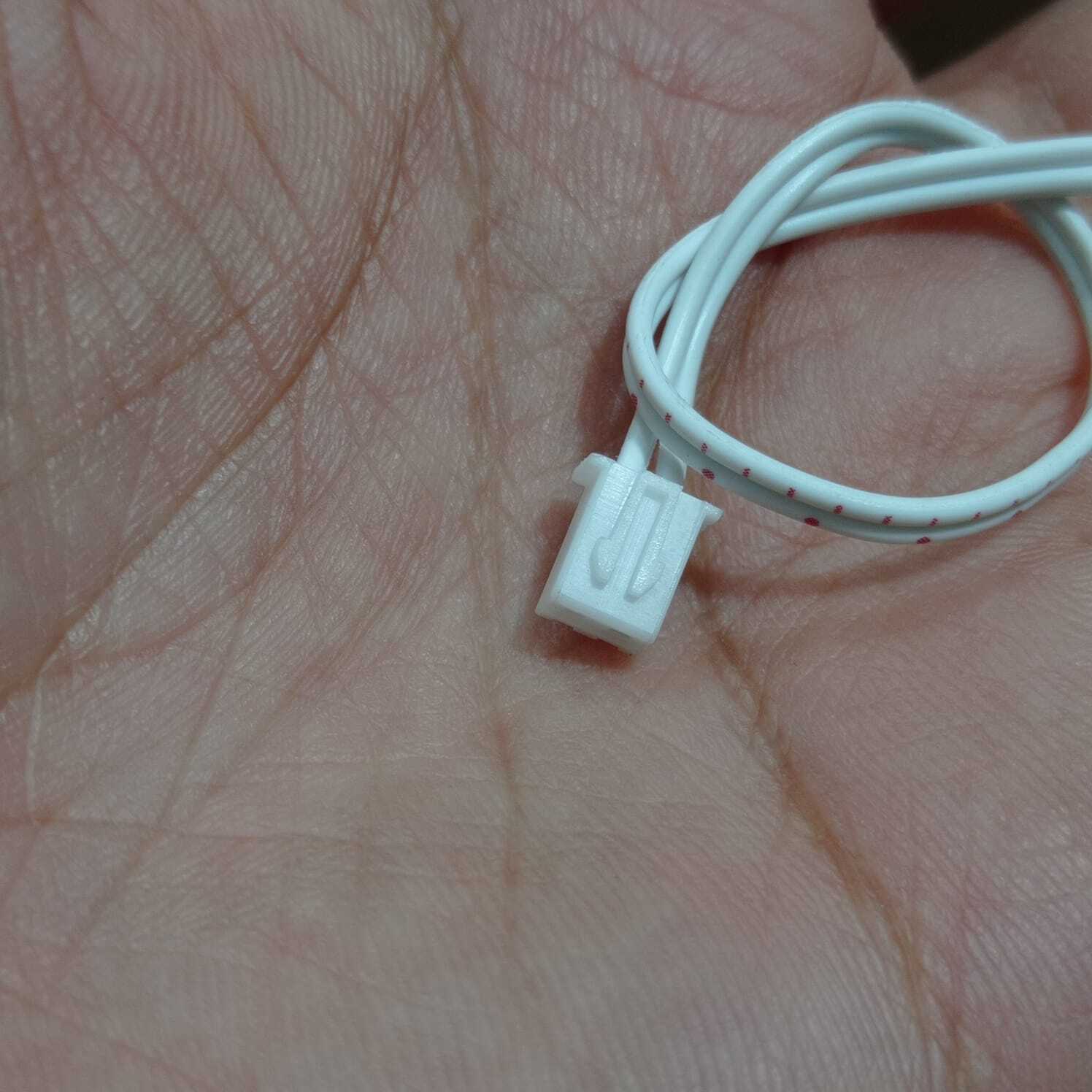 2 Wires 2.54mm Pitch Female JST Xh Connector Cable Wire - shown as a close-up of a white two-pin connector attached to two white wires held in a hand.
