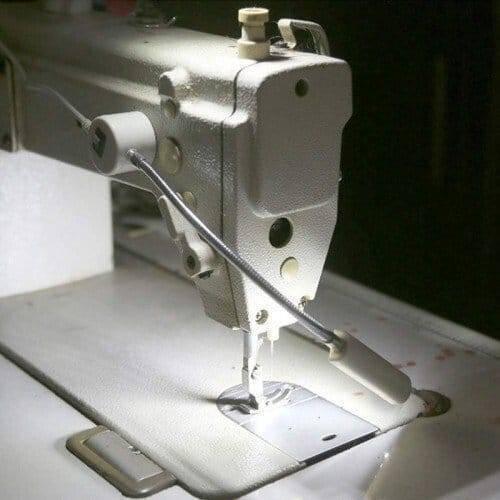 20 SMD LED Bendable Light Lamp 220V Magnetic Base Gooseneck Sewing Machine SMD Light Bulb - a white flexible gooseneck light with a magnetic base mounted on a sewing machine to illuminate the needle area.