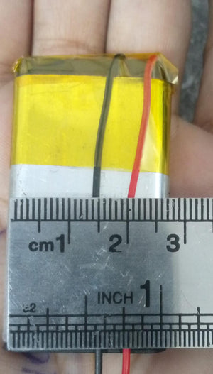 2000mAh 3.7V Lithium-ion battery - shown as a rectangular silver cell with yellow tape and red and black wires, measured against a metal ruler.