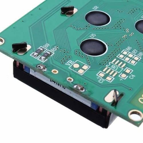 2004A 20x4 Character Blue Color LCD Display For Arduino - a close-up angle of the green circuit board, soldered pins, and black components.