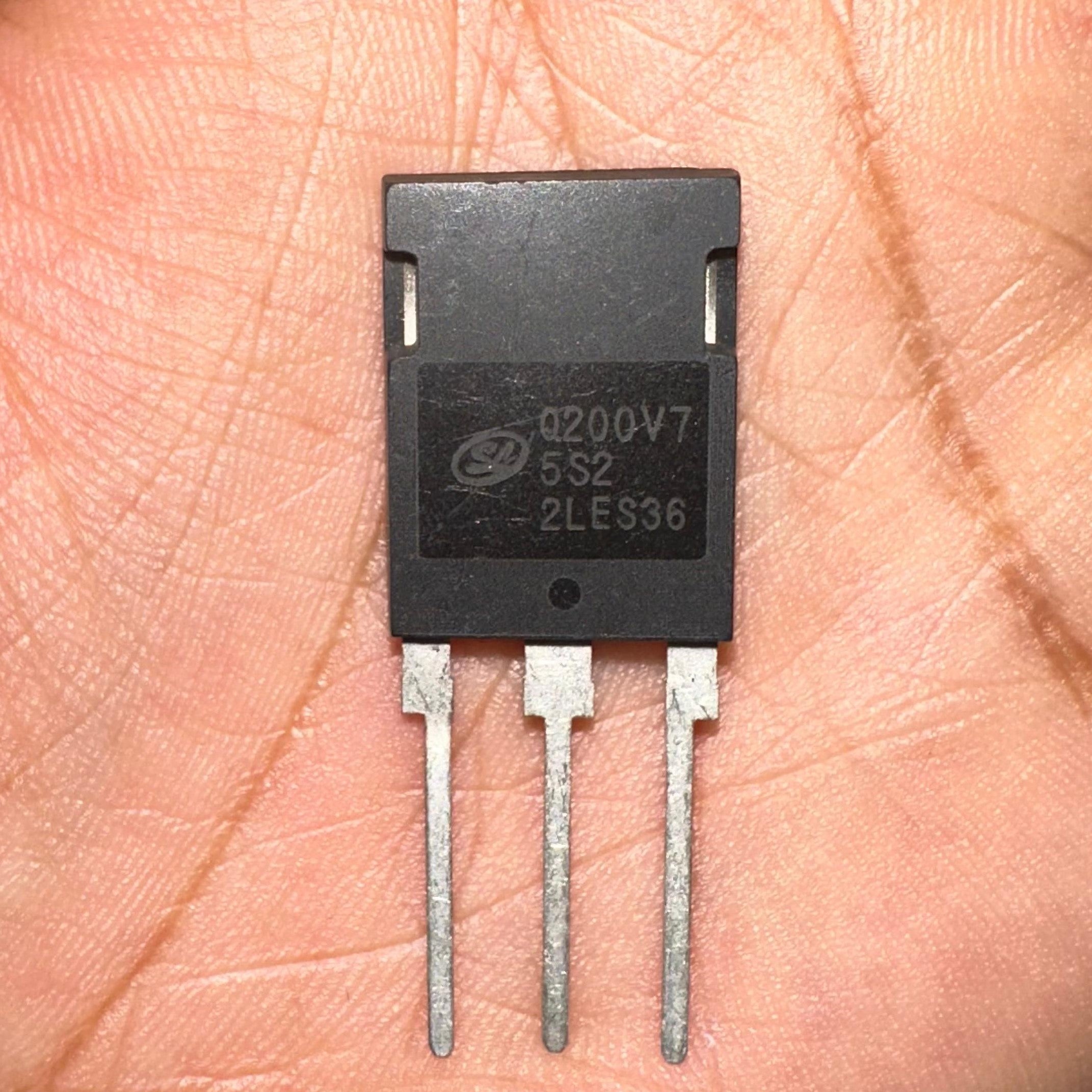 200A 750V IGBT Q200V75SDB1 SGTQ200V75SDB1-digilog.PK - a black three-pin electronic component held in a palm, showing the model number and manufacturer logo printed on its front surface.