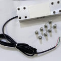 200kg Capacity Strain Guage Load Cell - a rectangular silver metal sensor with a black wire and eight small metal bolts arranged on a white surface.