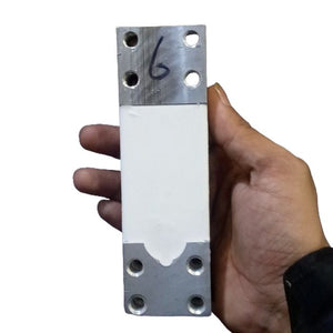 200kg Capacity Strain Guage Load Cell - Gauge Load Cell held in a hand, showing a rectangular metal and white ceramic sensor body with four mounting holes at each end.
