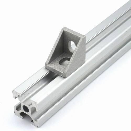 2020 Aluminum Profile l Bracket Corner Bracket - a silver-colored metal L-shaped bracket mounted onto a section of 2020 aluminum extrusion.