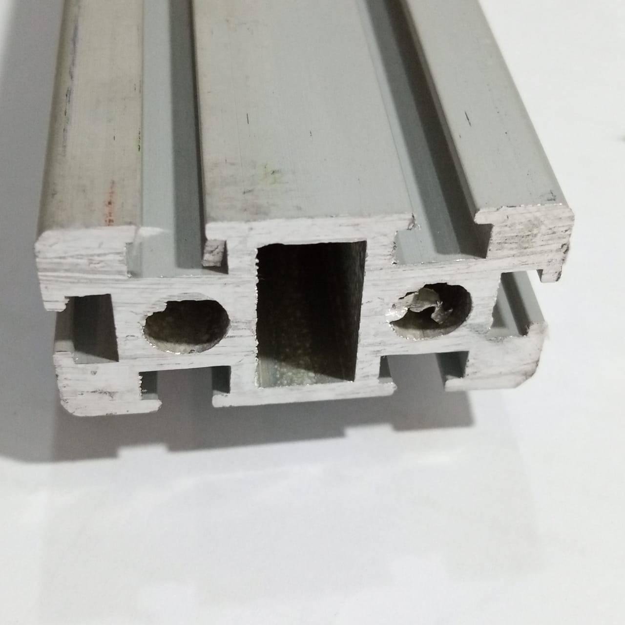 2040 Aluminium Profile Aluminium Extrusion For CNC And 3d Printer 1 Feet - a close-up of the silver metal extrusion showing its rectangular cross-section with T-slots and two circular internal holes.