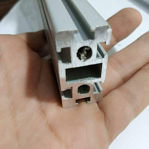 2040 Aluminium Profile Aluminium Extrusion For CNC And 3d Printer 1 Feet - a close-up view of the silver-coloured metal extrusion held in a hand, showing its T-slot cross-section and internal holes.