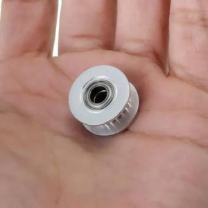 20T 5mm Bore 6mm Belt GT2 Timing Belt Idler Pulley With Bearing For 3d Printer - close-up shot of a small silver-colored metal pulley held in a person's palm.
