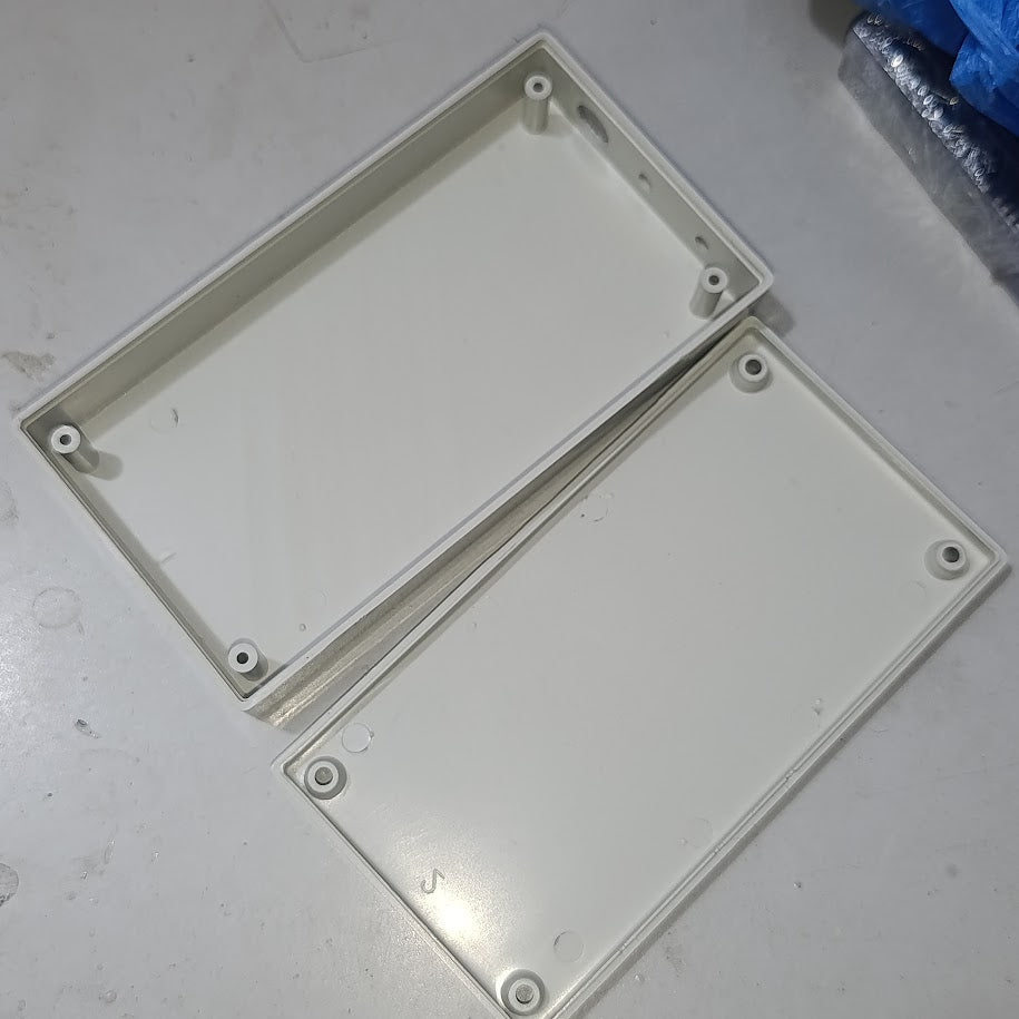 21700 18650 6x Cell Power Bank Case For WiFi Router And Other Devices - the two open halves of a rectangular, off-white plastic enclosure with internal screw mounting pillars.