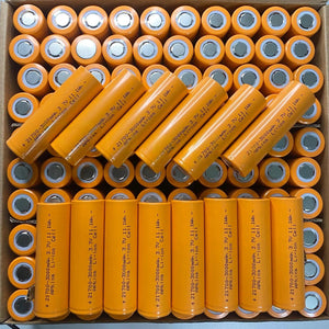 21700 3.7V 3000mA Lithium Ion Cell - shown as a bulk collection of orange cylindrical batteries arranged in rows inside a cardboard shipping box.