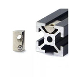 21mm x 13mm x 7mm M8 T Nut, Roll Ball Elastic Nuts For 4040 - shown as a silver metal nut next to a black aluminum extrusion profile with one nut inserted.