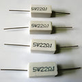 22 Ohm 5W - four rectangular white ceramic cement resistors with axial wire leads arranged in a vertical column against a white background.